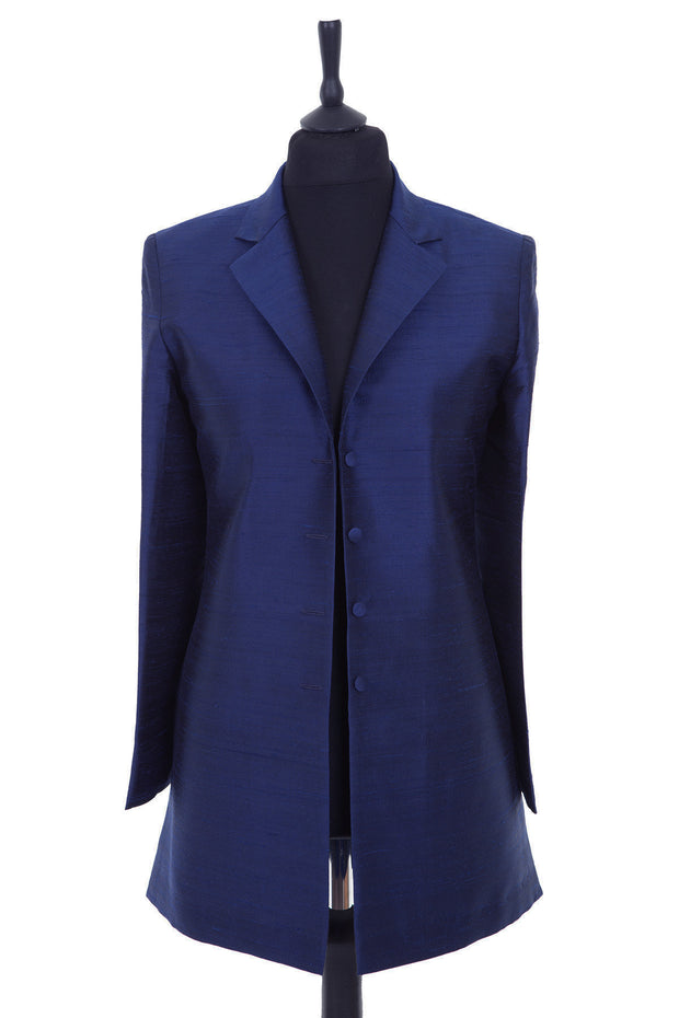 Womens longline blazer style jacket, with vents and revere collar. Shown here in a bright, rich navy blue plain raw silk.