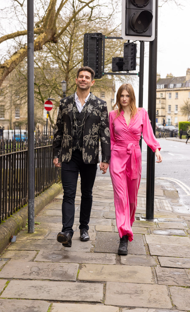 men walking in the City of Bath wearing Shibumi jacket with a young women in a pink silk Shibumi jumpsuit 