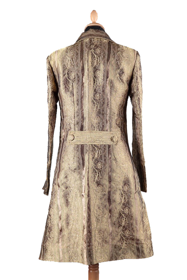 Back view of knee length gold colour coat for women. Fitted golden coat. 