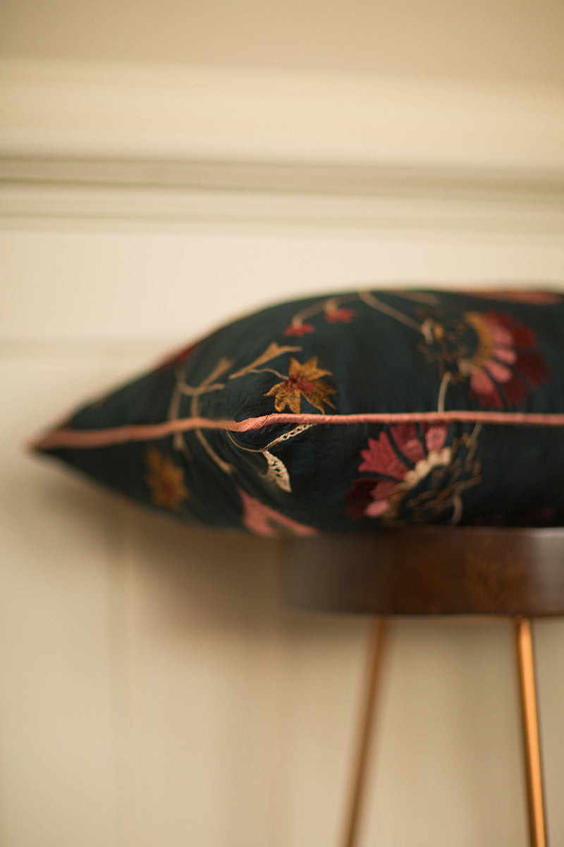 Dark green silk cushion with red flowers. 