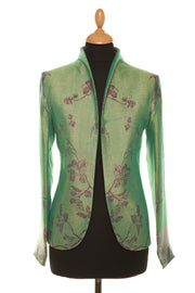Smart short women's silk jacket in green with floral pattern. 